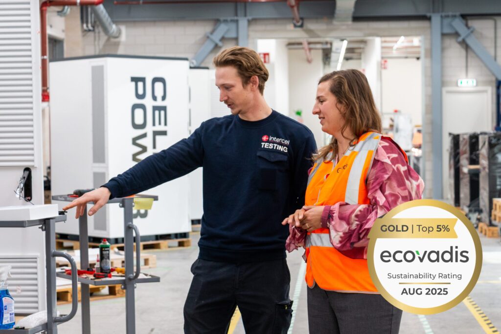 Ecovadis gold logo and: Responsibility and safety officers checking a ESS cabinet.